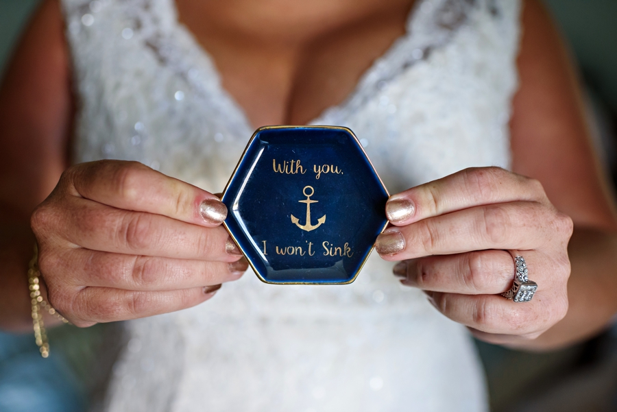 A bride holding a jewelry dish that she got as a gift from her bride to be.